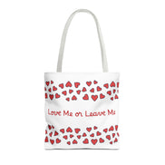 Tote bag with red heart pattern and text 'Love Me or Leave Me' on a white background