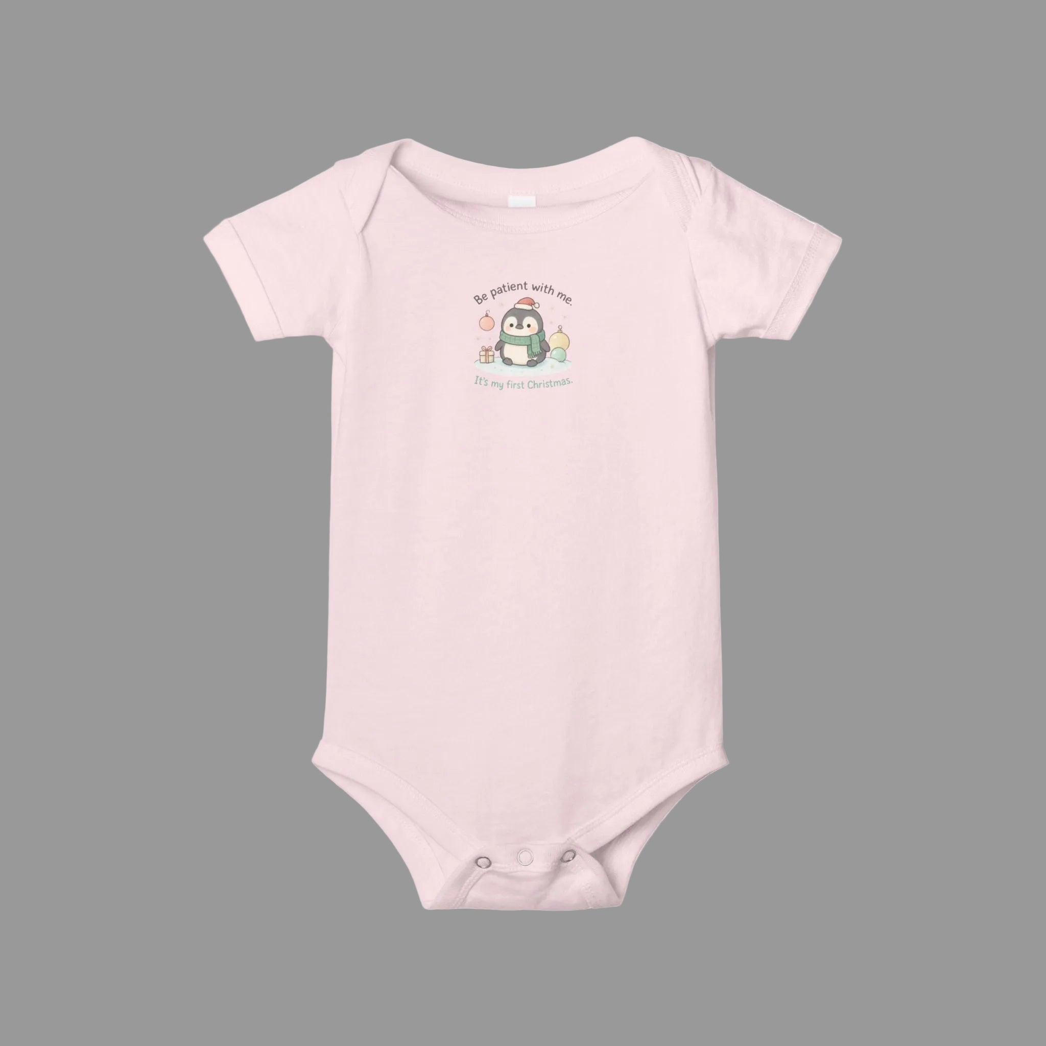 Pink baby onesie with a cartoon penguin design on a white background