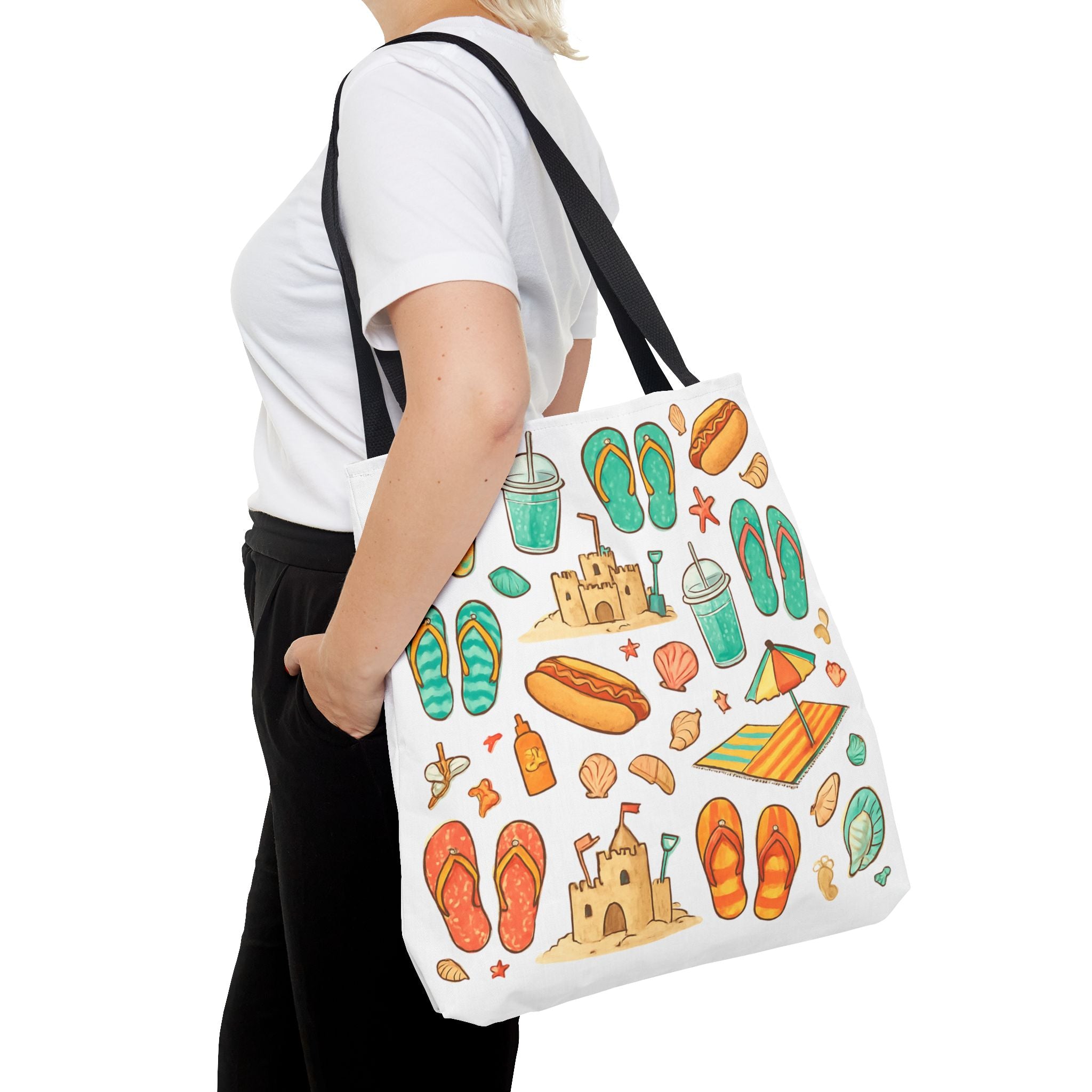 Person holding a tote bag with beach-themed designs on a white background