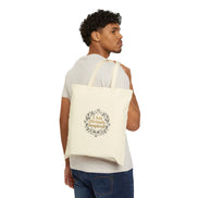 Man carrying a tote bag with 'I am Divinely Inspired' text on a white background