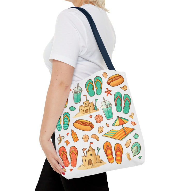 Person carrying a tote bag with beach-themed designs on a white background