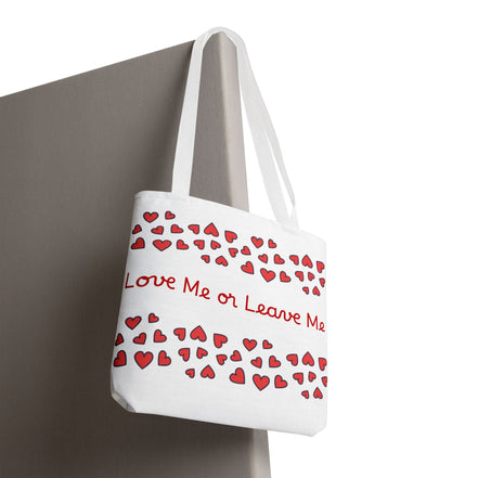 White tote bag with red heart patterns and text 'Love Me or Leave Me' on a white background