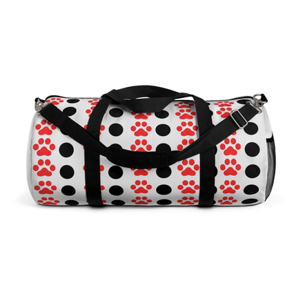 Duffel bag with black and red paw print pattern on a white background