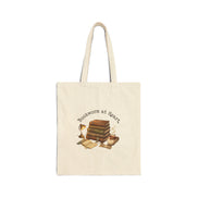 Beige tote bag with 'Bookworm at Heart' text and book-themed design on a white background