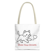 White tote bag with a beige handle and cat illustration and 'Chase Your Dreams' text on a white background
