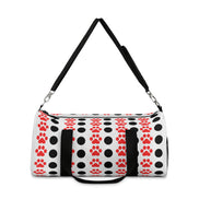 Duffel bag with black polka dots and red paw prints on a white background