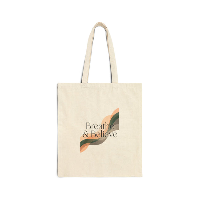 Beige tote bag with 'Breathe & Believe' text and leaf design on a white background