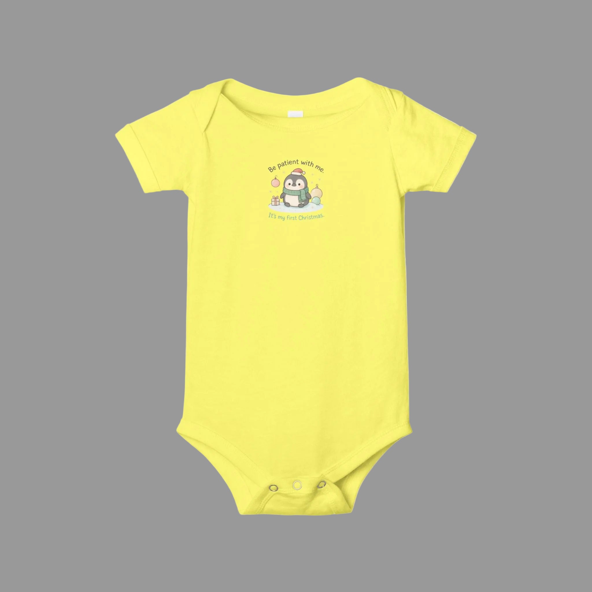 Yellow baby onesie with a cartoon penguin design on a white background