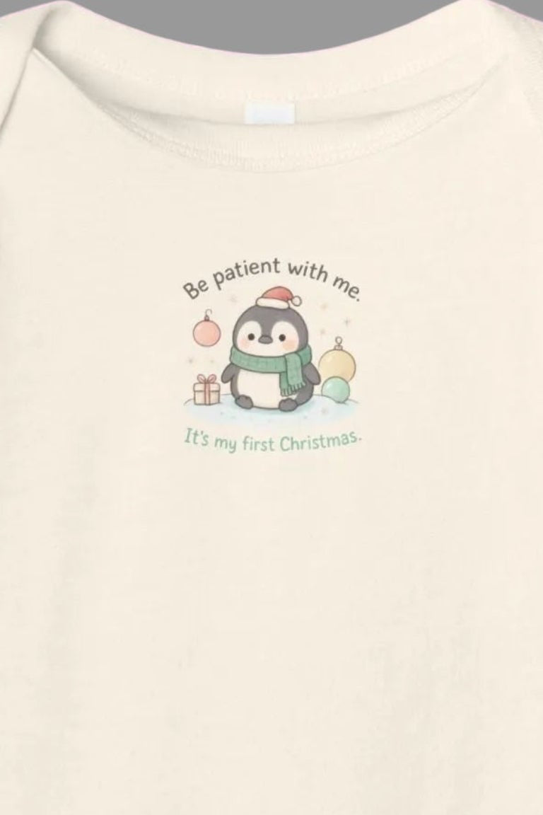 Baby onesie with a cartoon penguin design on a white background