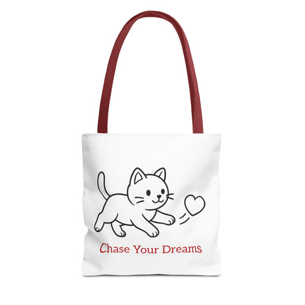 Tote bag with a red handle and cat illustration and 'Chase Your Dreams' text on a white background