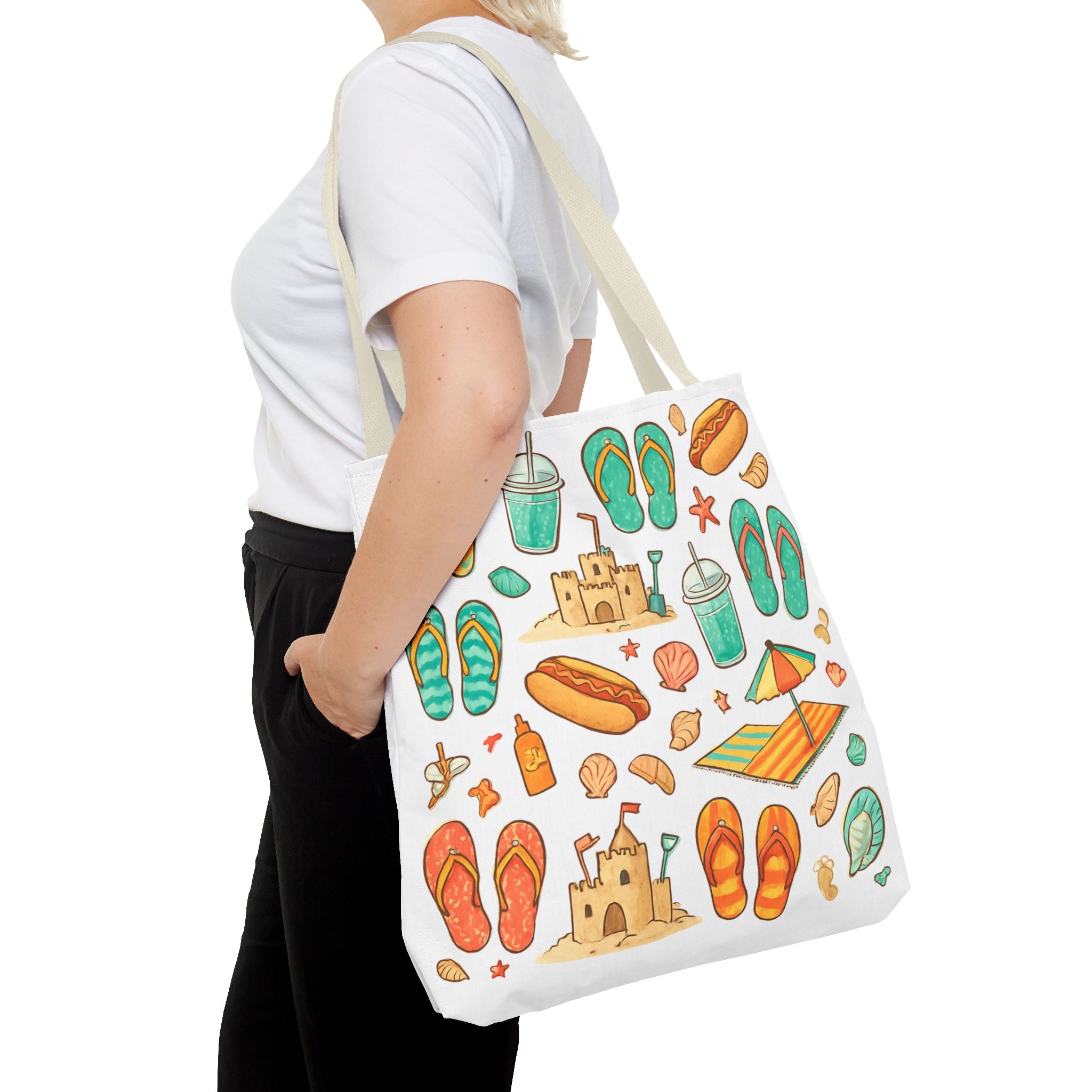 Person holding a tote bag with beach-themed designs on a white background