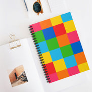 Colorful checkered notebook with a photo and clip on a white surface