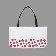 White tote bag with red heart pattern on a white background