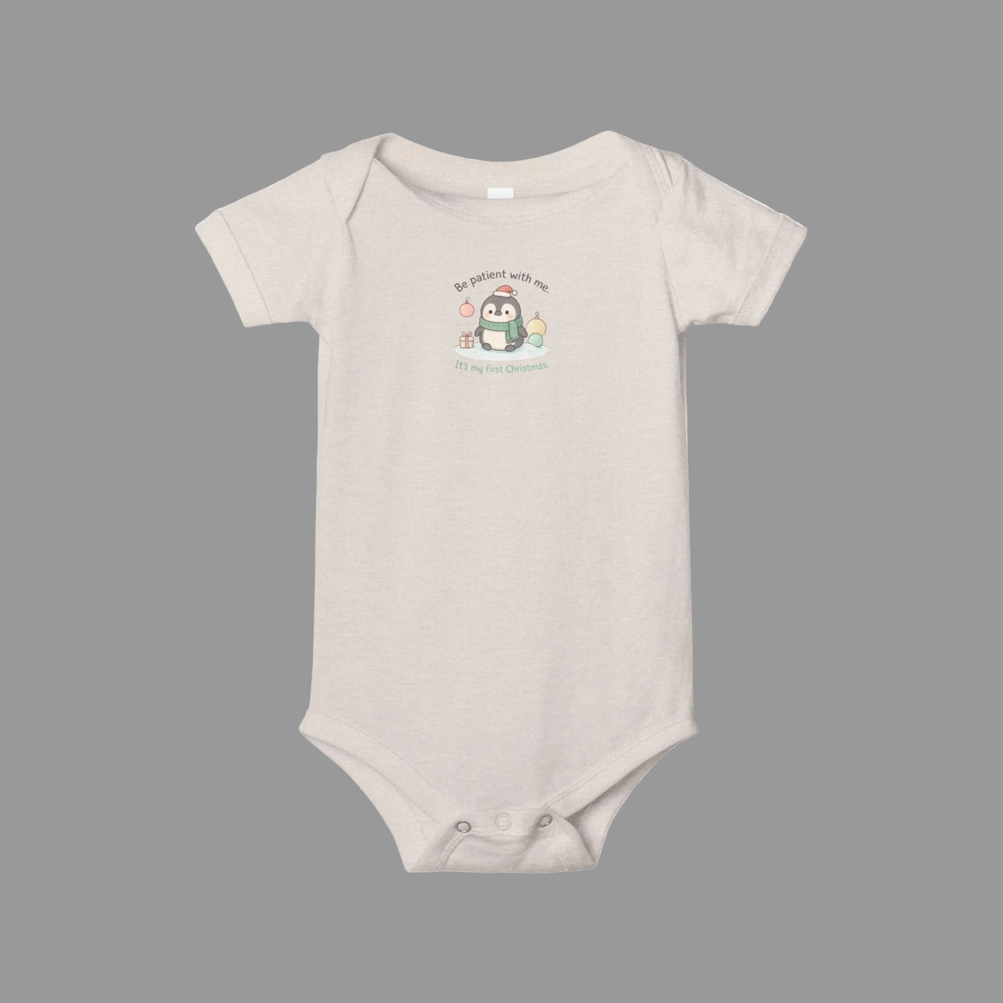 Beige baby onesie with a cartoon penguin design on a white background