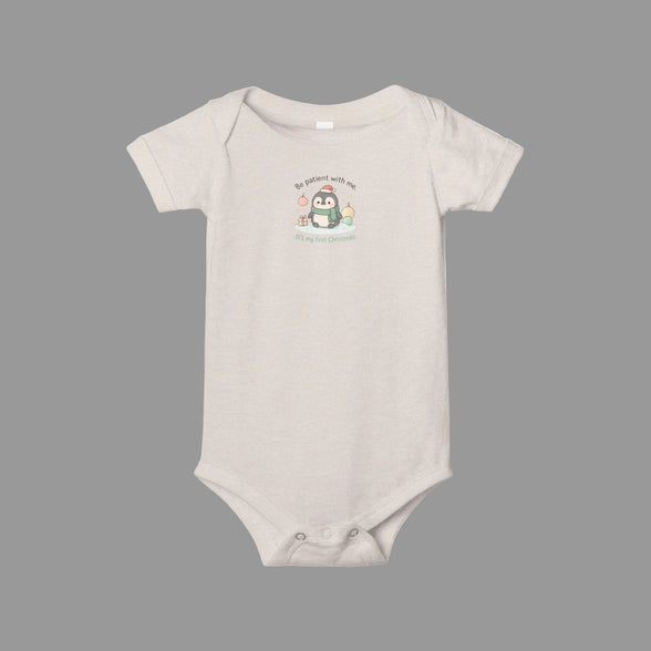 Beige baby onesie with a cartoon penguin design on a white background