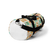 Duffel bag with a colorful pattern and black strap on a white background
