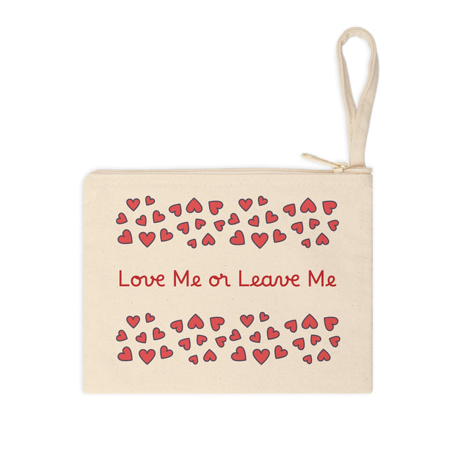 Beige pouch with red hearts and 'Love Me or Leave Me' text on a white background