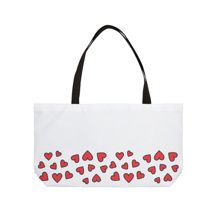 White tote bag with red heart patterns on a white background
