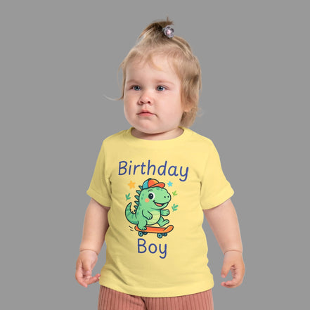 Birthday Boy baby t-shirt with cute skateboarding dinosaur first birthday design. Child wearing a yellow t-shirt with a dinosaur graphic and text on a white background