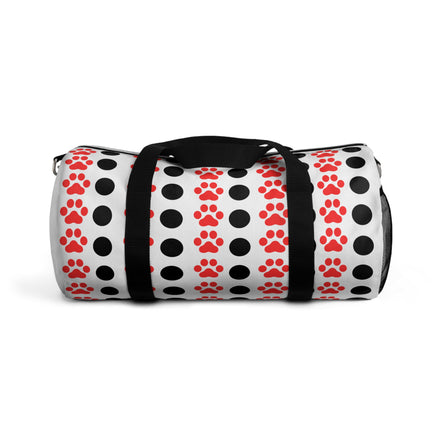 Duffel bag with red paw prints and black polka dots on a white background