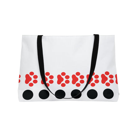 White tote bag with red paw prints and black circles on a white background