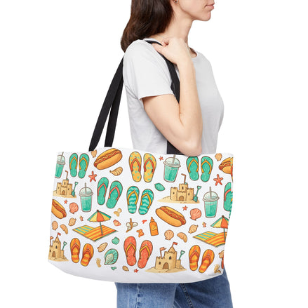 Person holding a tote bag with beach-themed design on a white background