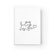 Framed artwork of a black line drawing of a cat holding a heart on a white background