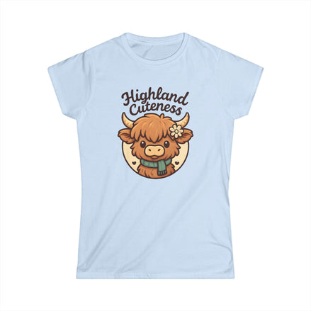 Light blue t-shirt with a cartoon Highland cow and 'Highland Cuteness' text on a white background