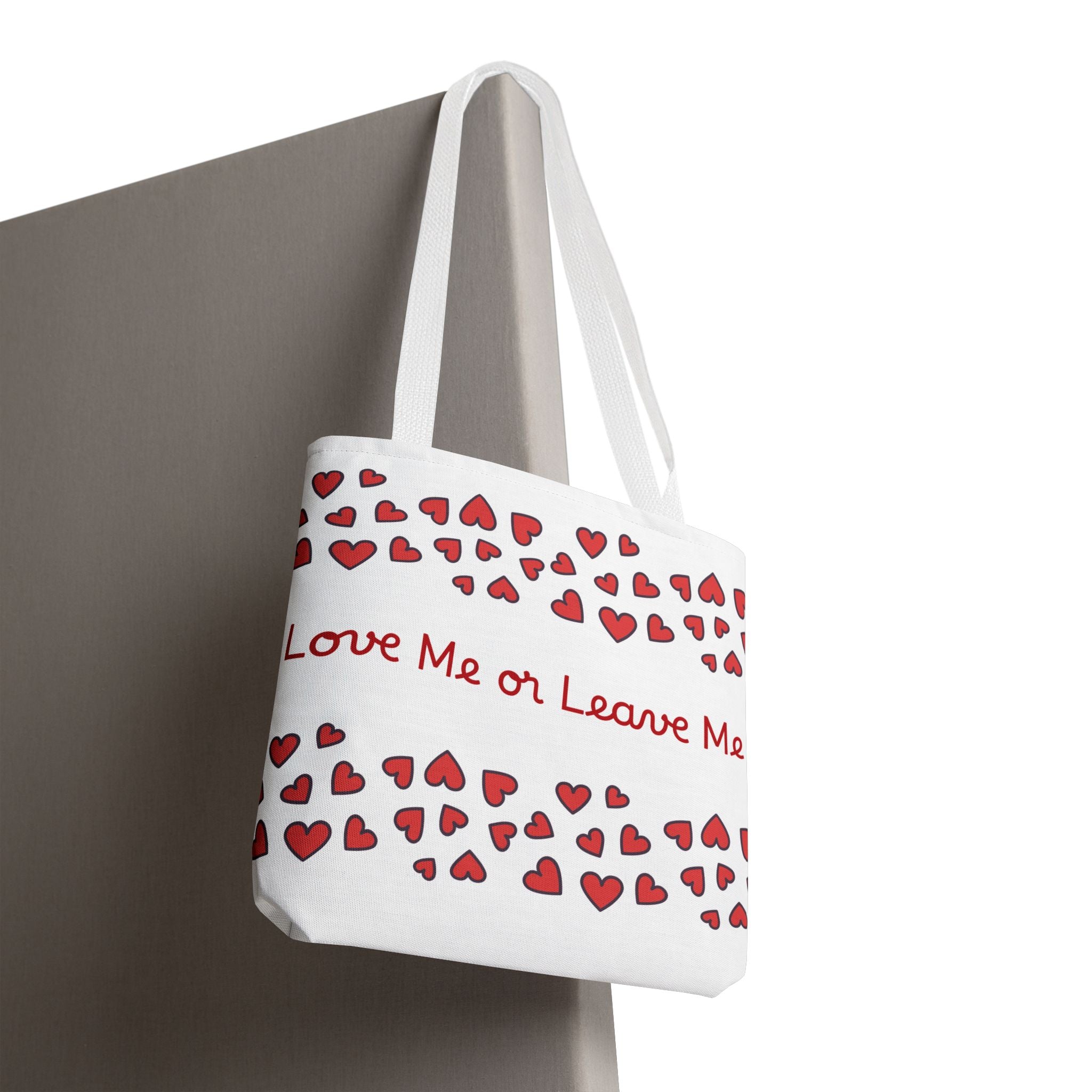 Tote bag with red heart pattern and text 'Love Me or Leave Me' on a white background
