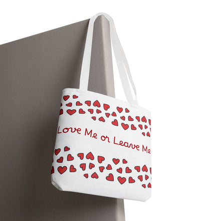 Tote bag with red heart pattern and text 'Love Me or Leave Me' on a white background