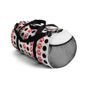 Pet carrier with black, white, and red paw pattern on a white background