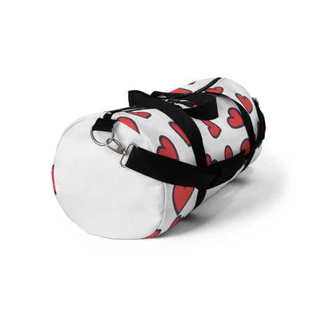 White duffel bag with red heart pattern and black straps on a white background