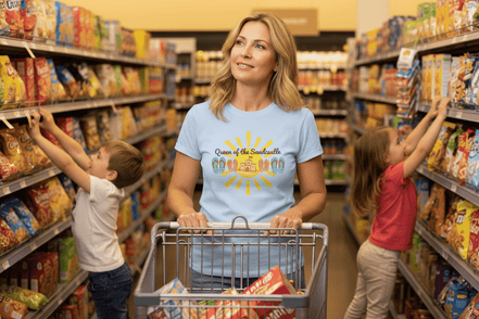 A woman wearing a shirt that say queen of the sandcastle shape with two rowdy kids