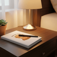 a highland hugs unlined journal on a side table with a pen over it