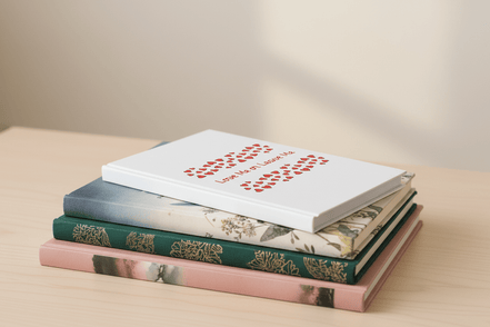 Stack of books with various covers on a light surface