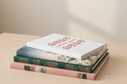 Stack of books with various covers on a light surface